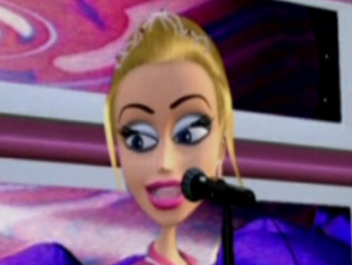 Burdine is blonde with white skin. She wears bright pink clothing, bright pink lipstick, and white and blue eyeshadow. Her hair is worn up with a silver tiara in it. She is standing at a microphone.